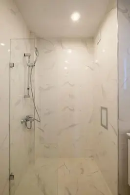a bathroom with a shower with a glass door at Central located 1BDR peaceful apt Fast Wi-fi in Sofia