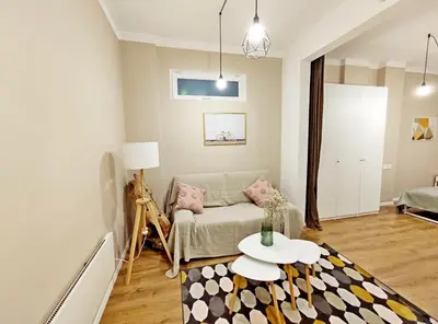 a living room with a couch and a table at Top Centre 1 Bedroom Apt next to Vitosha Blvd. in Sofia