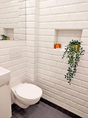 a white bathroom with a toilet and a plant at Top Centre 1 Bedroom Apt next to Vitosha Blvd. in Sofia