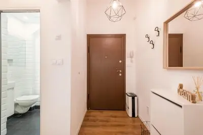 a bathroom with a toilet and a sink and a mirror at Top Centre 1 Bedroom Apt next to Vitosha Blvd. in Sofia