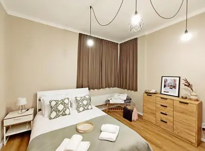 a bedroom with a large bed and a dresser at Top Centre 1 Bedroom Apt next to Vitosha Blvd. in Sofia