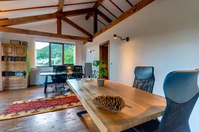 a dining room with a wooden table and chairs at The Pine Living - Ski & SPA in Lyevochevo