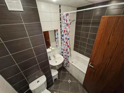 a small bathroom with a toilet and a sink at Sunny Apartment C25 in Borovets