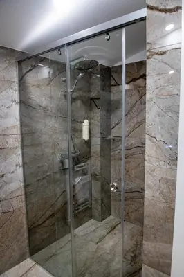 a shower with a glass door in a bathroom at Agora Boutique Hotel in Sofia