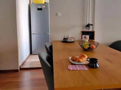 a table with a plate of croissants and a bowl on it at Specious Modern Apartment in Sofia