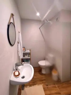 a bathroom with a sink and a toilet at Specious Modern Apartment in Sofia