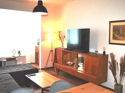 a living room with a flat screen tv on a entertainment center at Specious Modern Apartment in Sofia