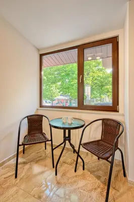 a room with a table and two chairs and a window at Къща за гости Relax in Hisarya