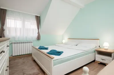 a bedroom with a white bed and a window at Serdika Old City House in Sofia