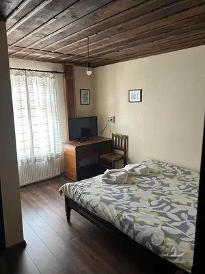a bedroom with a bed and a desk with a computer at Guest House Popov in Marchevo