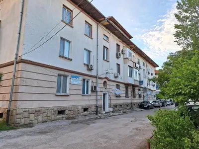 a large white building on the side of a street at Apartment Airport Sofia in Sofia