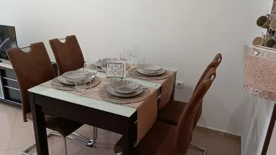 a dining room table with plates and wine glasses at Serenity Apt Iztok Sofia in Sofia