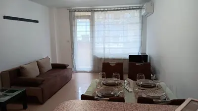 a living room with a couch and a table at Serenity Apt Iztok Sofia in Sofia