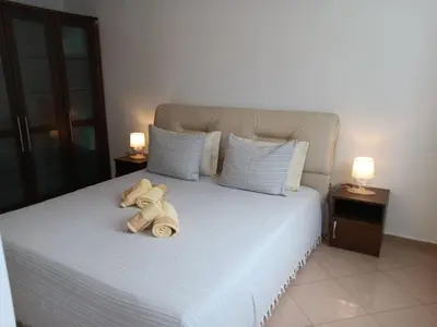 a bedroom with a bed with towels on it at Serenity Apt Iztok Sofia in Sofia