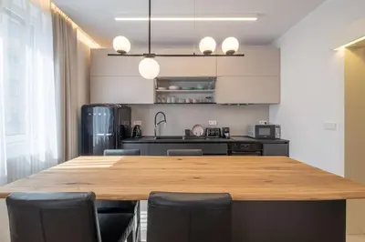 a kitchen with a large wooden table and black chairs at Top-Notch location, an Exceptionally Stylish flat in Sofia