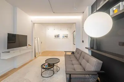 a living room with a couch and a tv at Top-Notch location, an Exceptionally Stylish flat in Sofia