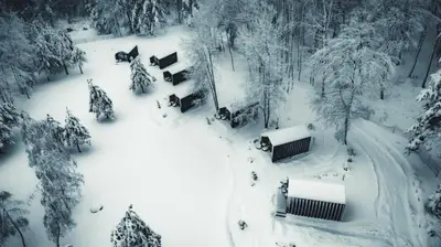 a snow covered park with benches and trees at Saint Constantine Mountain Retreat in Peshtera