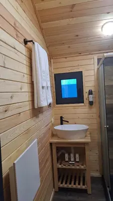 a bathroom with a sink and a tv on the wall at Saint Constantine Mountain Retreat in Peshtera