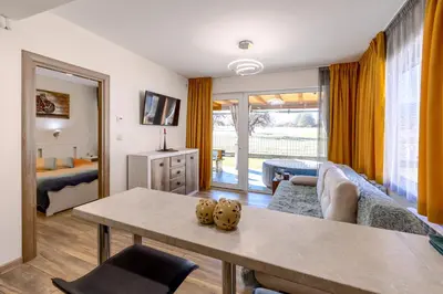a living room with a couch and a table at Villa Nikol Apt #2 in Raduil