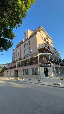a large building on the side of a street at Soflu apartments Plovdiv in Plovdiv