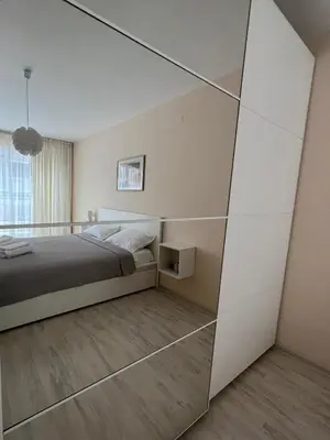 a bedroom with a bed and a large mirror at Soflu apartments Plovdiv in Plovdiv