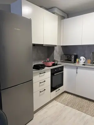 a kitchen with white appliances and white cabinets at Soflu apartments Plovdiv in Plovdiv