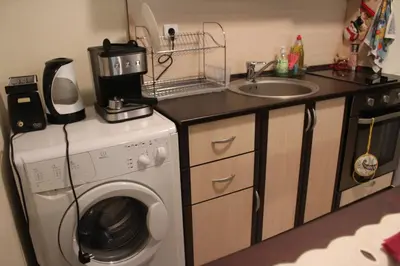 a kitchen with a washing machine and a sink at Apartment in Forest Glade Hotel in Pamporovo