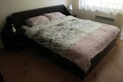 a bed with a comforter on it in a bedroom at Apartment in Forest Glade Hotel in Pamporovo