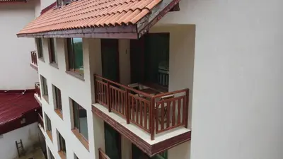 a balcony of a building with a red roof at Apartment in Forest Glade Hotel in Pamporovo