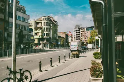 a bike parked on the side of a city street at Cityscape Luxury Suites in Plovdiv