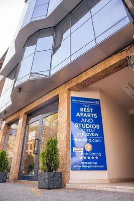 a building with a sign on the side of it at Cityscape Luxury Suites in Plovdiv
