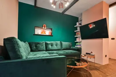 a living room with a green couch and a tv at Lozenetz Gem Cozy 1-Bedroom Apartment in Sofia by Flat Mаnager in Sofia