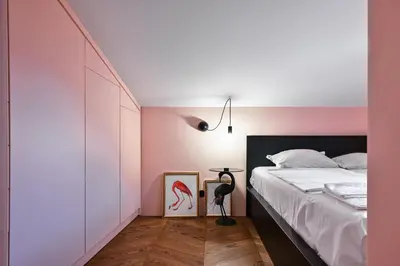 a bedroom with a bed and a pink wall at Lozenetz Gem Cozy 1-Bedroom Apartment in Sofia by Flat Mаnager in Sofia