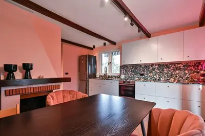 a kitchen with a wooden table and orange chairs at Lozenetz Gem Cozy 1-Bedroom Apartment in Sofia by Flat Mаnager in Sofia