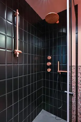 a bathroom with a shower with black tiles at Lozenetz Gem Cozy 1-Bedroom Apartment in Sofia by Flat Mаnager in Sofia