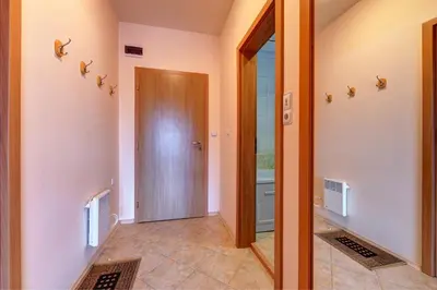 a hallway with a door leading to a bathroom at Panorama Studio in Stoykite
