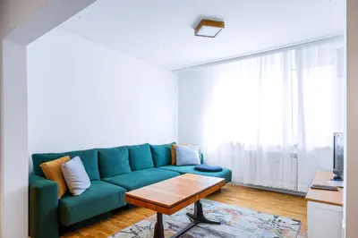 a living room with a green couch and a coffee table at Contemporary Comfort 1BD Flat in Lozenetz, Sofia by Flat Mаnager in Sofia