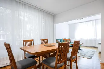 a dining room with a wooden table and chairs at Contemporary Comfort 1BD Flat in Lozenetz, Sofia by Flat Mаnager in Sofia