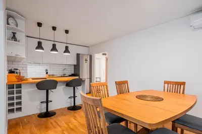 a kitchen and dining room with a wooden table and chairs at Contemporary Comfort 1BD Flat in Lozenetz, Sofia by Flat Mаnager in Sofia