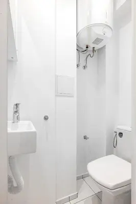 a white bathroom with a toilet and a sink at Contemporary Comfort 1BD Flat in Lozenetz, Sofia by Flat Mаnager in Sofia