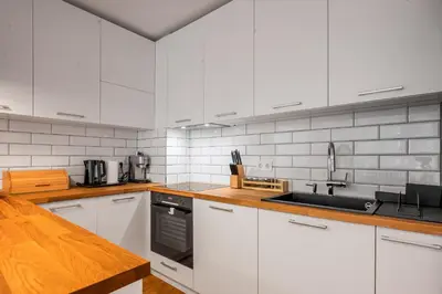 a kitchen with white cabinets and a sink at Contemporary Comfort 1BD Flat in Lozenetz, Sofia by Flat Mаnager in Sofia
