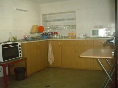 a kitchen with wooden cabinets and a microwave at Villa Shipkovo in Shipkovo