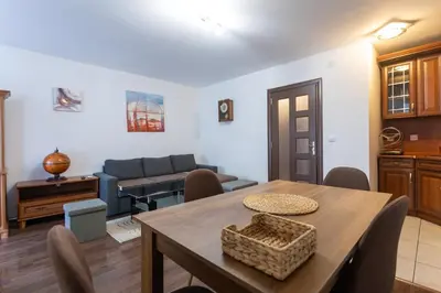 a living room with a table and a couch at Karastoyanovi's apartment 3 in Sofia