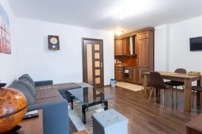 a living room with a couch and a table at Karastoyanovi's apartment 3 in Sofia