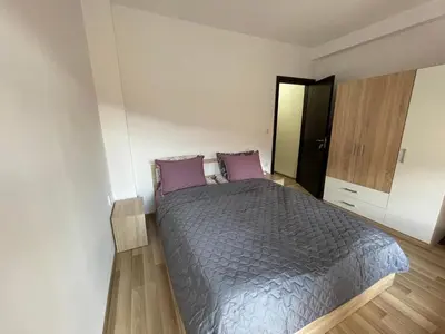 a bedroom with a bed with purple pillows at Hancho - Velingrad - Marvel Apartament in Velingrad
