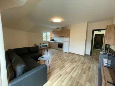 a living room with a couch and a kitchen at Hancho - Velingrad - Marvel Apartament in Velingrad