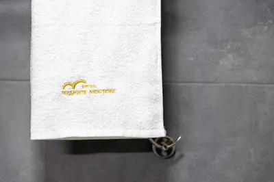 a white towel with a pair of scissors under it at Къща за гости Чудните Мостове in Zabŭrdo