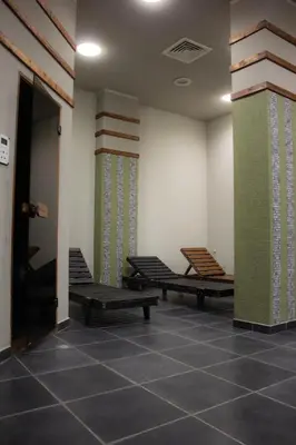 a room with two benches and a wall with windows at Aspen Valley Sun Rays A102 in Razlog