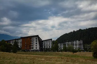 a group of buildings in a field with trees at Aspen Valley Sun Rays A102 in Razlog
