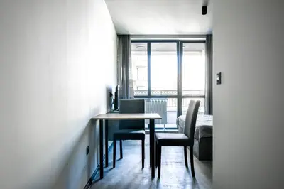 a table and chairs in a room with a window at 6 Studios 6 Bathrooms 2 Levels Kitchens in Sofia